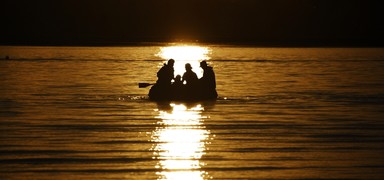  Taken at Bucklands Beach looking onto Kohimarama. A family catches the sunset on an inflatable boat.