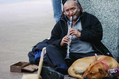 Jason Lee; Man and his dog; Between smiles, playing music for the passers by
