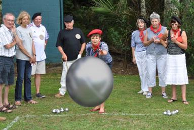 phil and yvonne morton; TWFSPetanque; A contestant launches a boule towards the camera during this year's  Valentines' Day picnic of the Titirangi Wine and Food Society