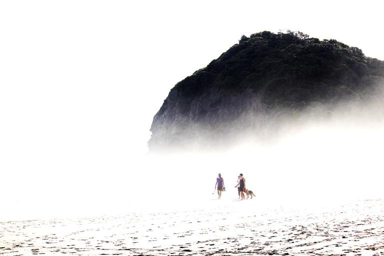 naleen verma;piha beach;captured few people walking on the sands thrugh the ocean mist