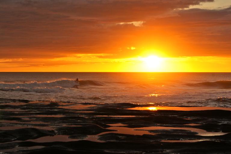 Ben Crowle; Last Light; Surfer making the last of the fading light at muriwai beach