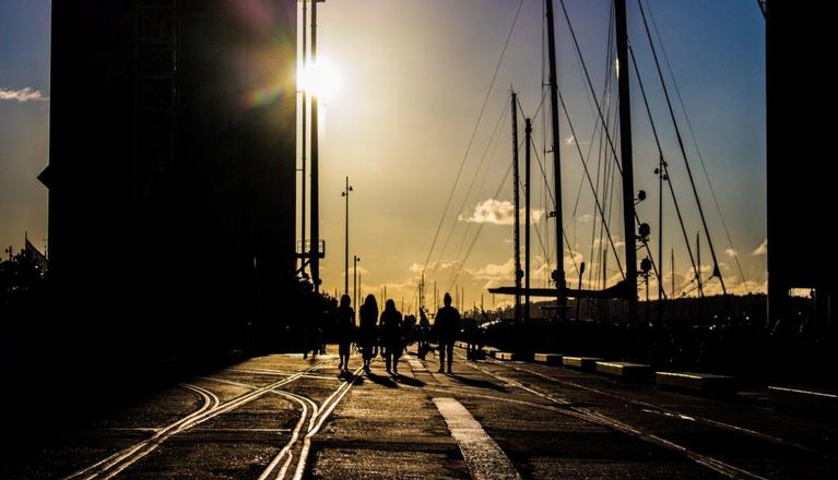 Edward Swift;Time to go home;Four people walk down Wynyard Quarter as the sun sets