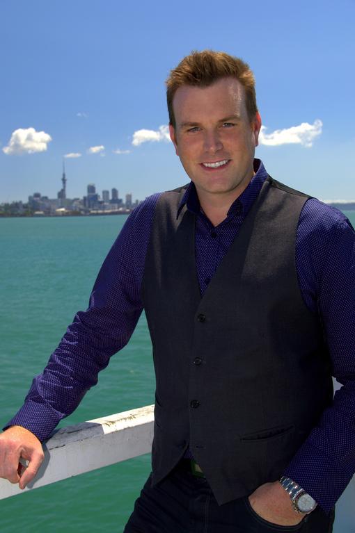 Auckland magician Mick Peck pictured at Okahu Bay, Auckland skyline in background
