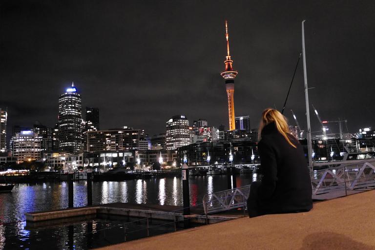Having a moment of silence while looking at the Skytower, lit up in orange for Matariki Festival celebrating Maori New Year. The picture is also taken to capture the matching contrast between tower, hair and ground to create a connection.