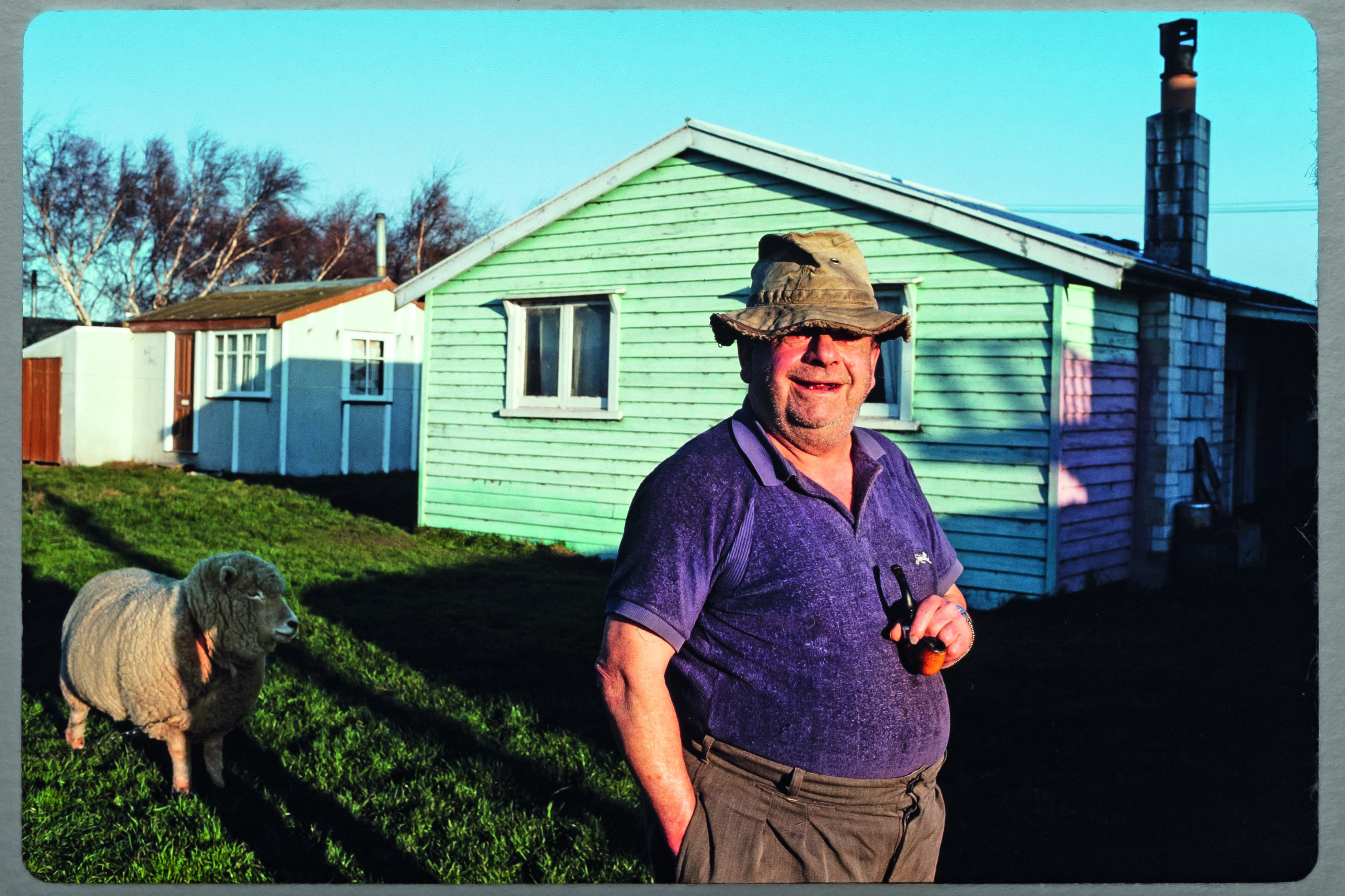 Robin Morrison. 1979. Norm Smith with his pet sheep, Pebbles. Greenpark Huts. Auckland Museum. © Robin Morrison Estate