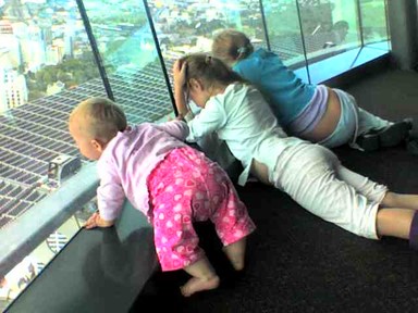 Tavia Khaine; Sisters Flying high; Sharni, 8 mths, on her first skytower visit, with her big sisters watching the jumpers, its just a phone pxt but we love it!