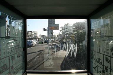  This is a photo taken from inside the busstop in three lamps. It looks down Jervois Road