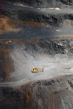 A digger is dwarfed by the quarry it dug, South Auckland. 2009