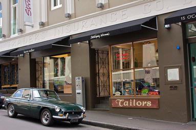 Richard Hayton; Strangely Normal; Sunday afternoon in Auckland CBD, O'Connell Street. Came across this scene of an old MGB and it really fitted the street and shop.