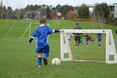  A little girl proving fancy hair Doo's help to score goals!