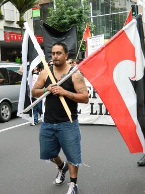 Occupy Auckland Protest; Flag bearer leads the walk up Queen St