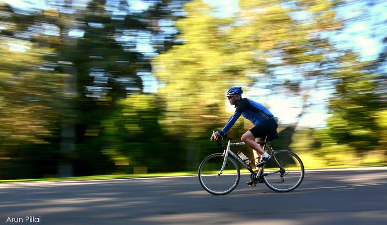 Arun Sarasakshan Pillai; I am fast..; Panning shot of a biker from Cornwall Park, Auckland