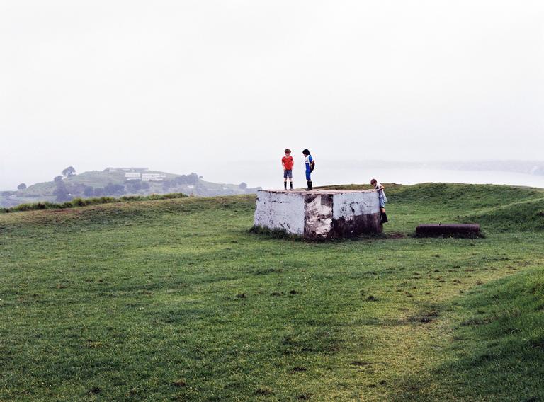 View from Takarunga (previously Mt Victoria) of boys playing on the bunker on a rainy day. Shot with medium format film.