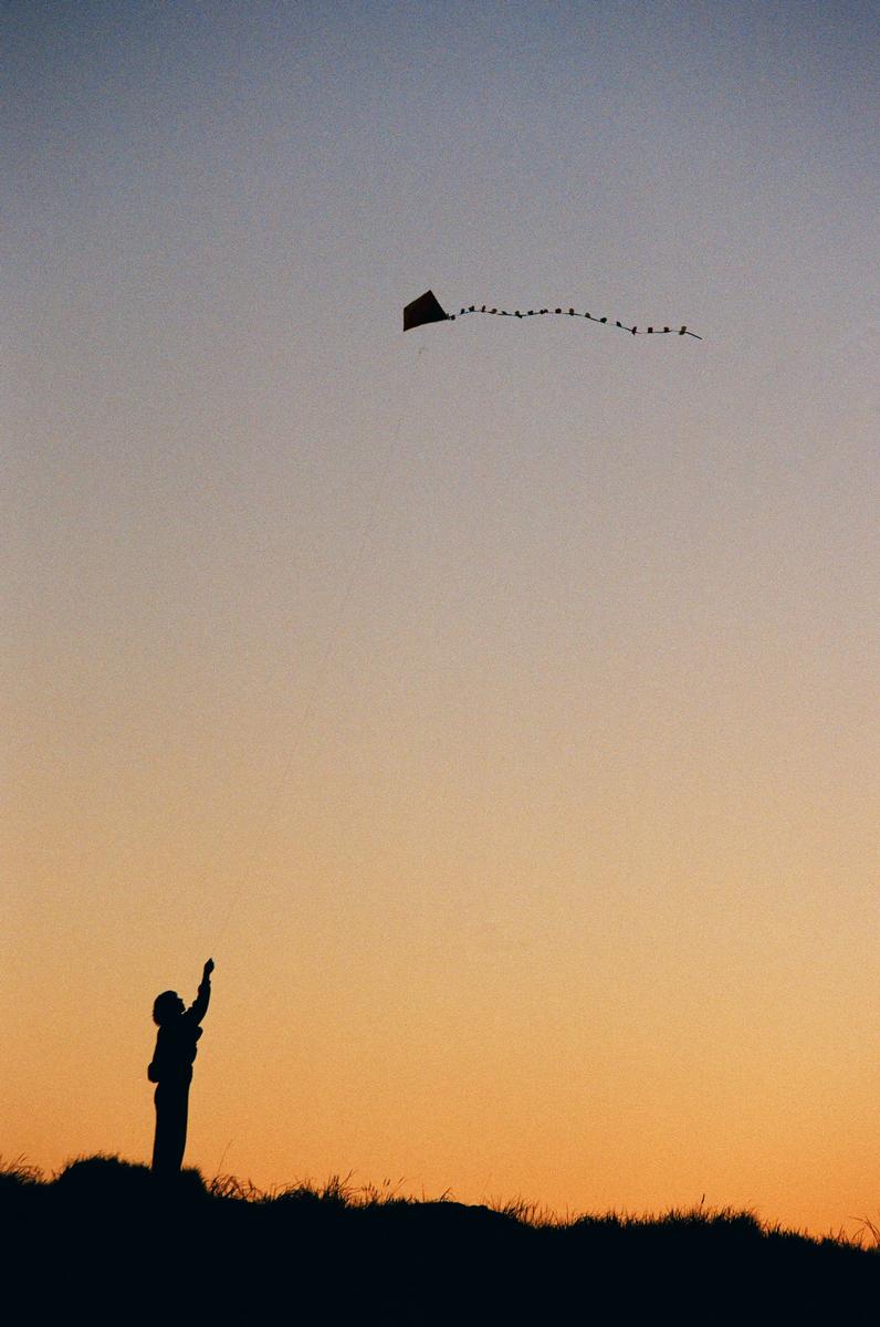 Matt Hurley; Sunset Flight; Photographed using 35mm Kodak ColourPlus film, a woman on top of Mangere mountain after the sun set.