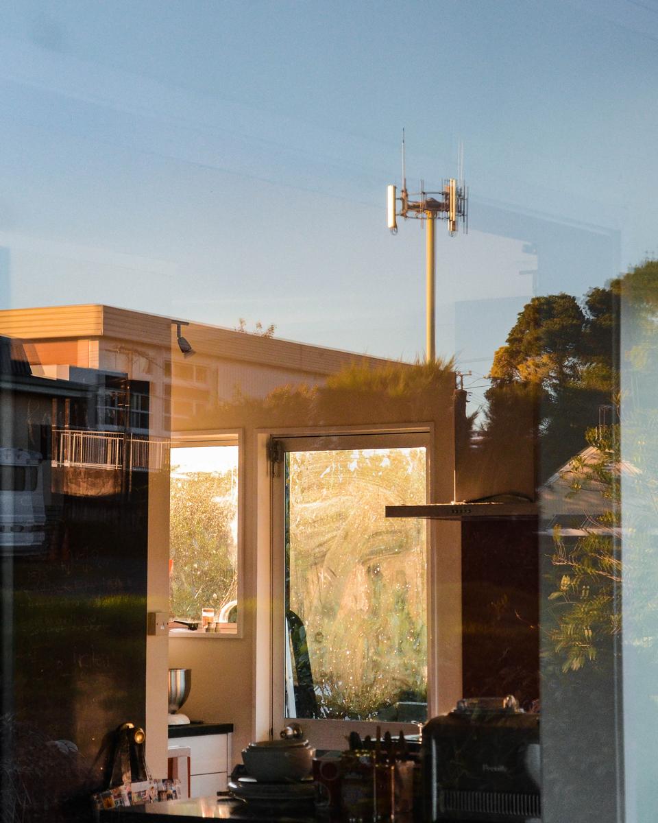 Angel Jacobson; Seeing Double; A singular photo, seemingly taken using double exposure, showing the inside of the house and the view.