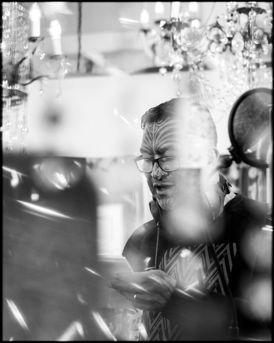 Amanda Ratcliffe; Rob Ruha at Roundhead Studios   Auckland, 2020;Rob Ruha at Roundhead Studios during a songwriting session at SongHubs (Auckland) 2020. This image was captured through hand made chandeliers in the studio. No filter has been used to create this piece.