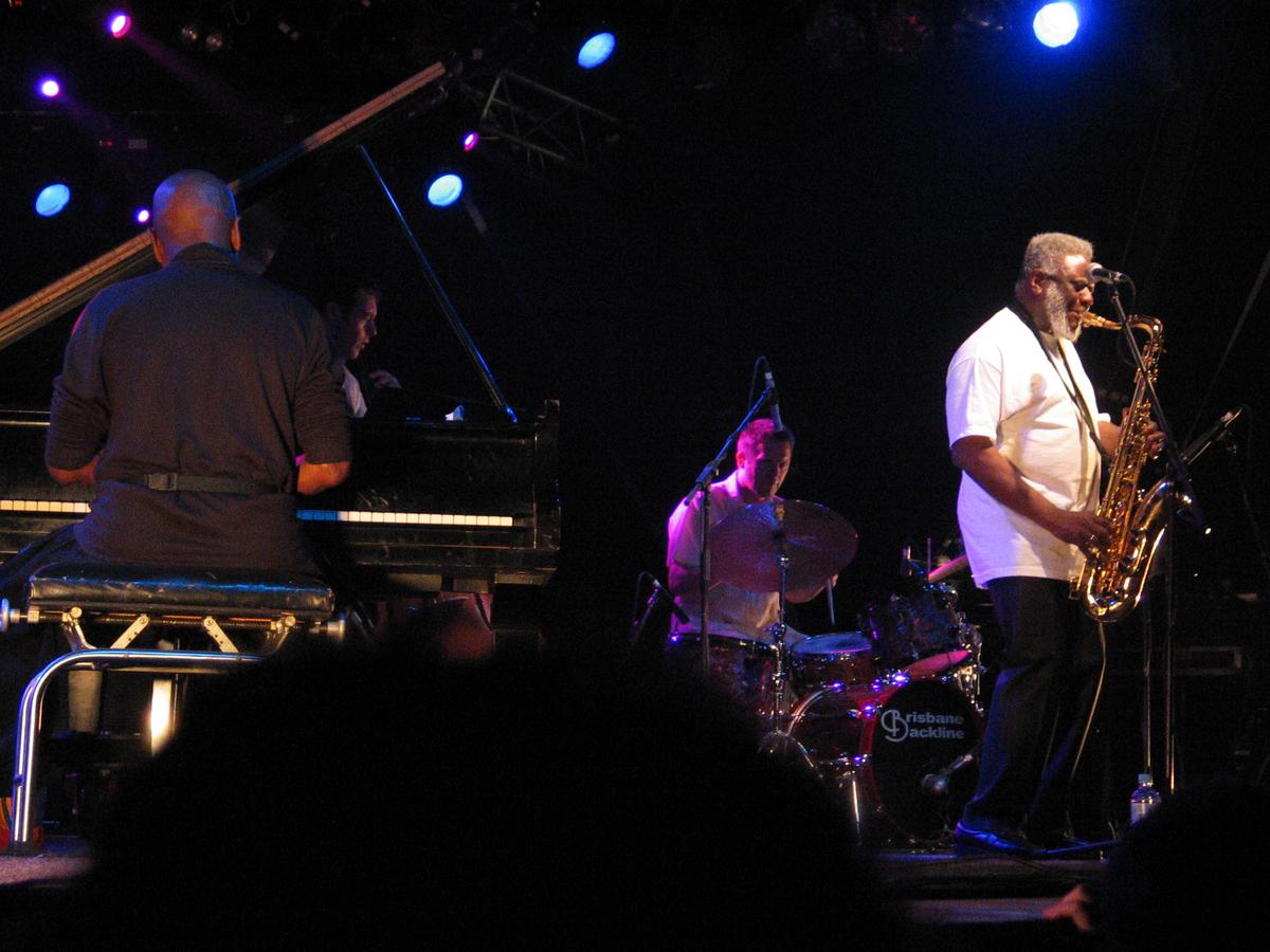 Bruce Buchanan; Pharoah Sanders Quartet Byron Bay 2004;I always loved the facial expressions of the drum and bass. Working with the master out front. I think I lucked the lighting as well. Canon G3 good in its day