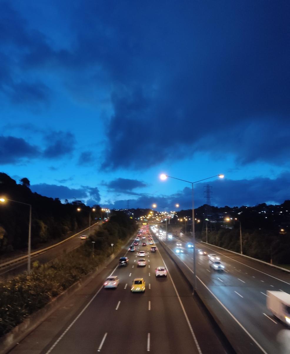 Kate Lim;On my way home.;As I was walking on the bridge passed the motorway, I noticed the blue like a blanket hovering the traffic.