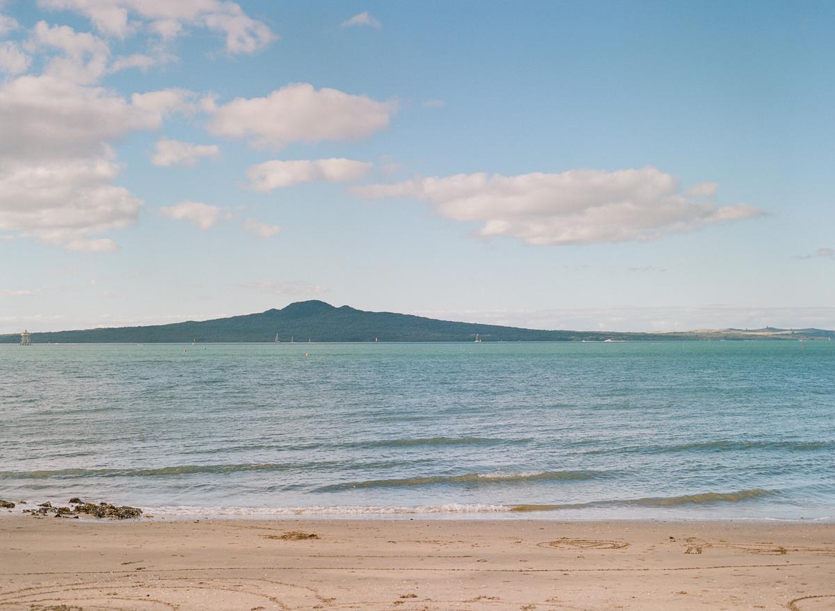 Rachel Sung;Picturesque;This film photograph was taken in Mission Bay last year and upon seeing the photograph, I thought it looked too perfect to be real. The saturated colours of the sand and the sea make it seem like it’s painted on, and Rangitoto Island on the horizon just looks visually appealing to me.