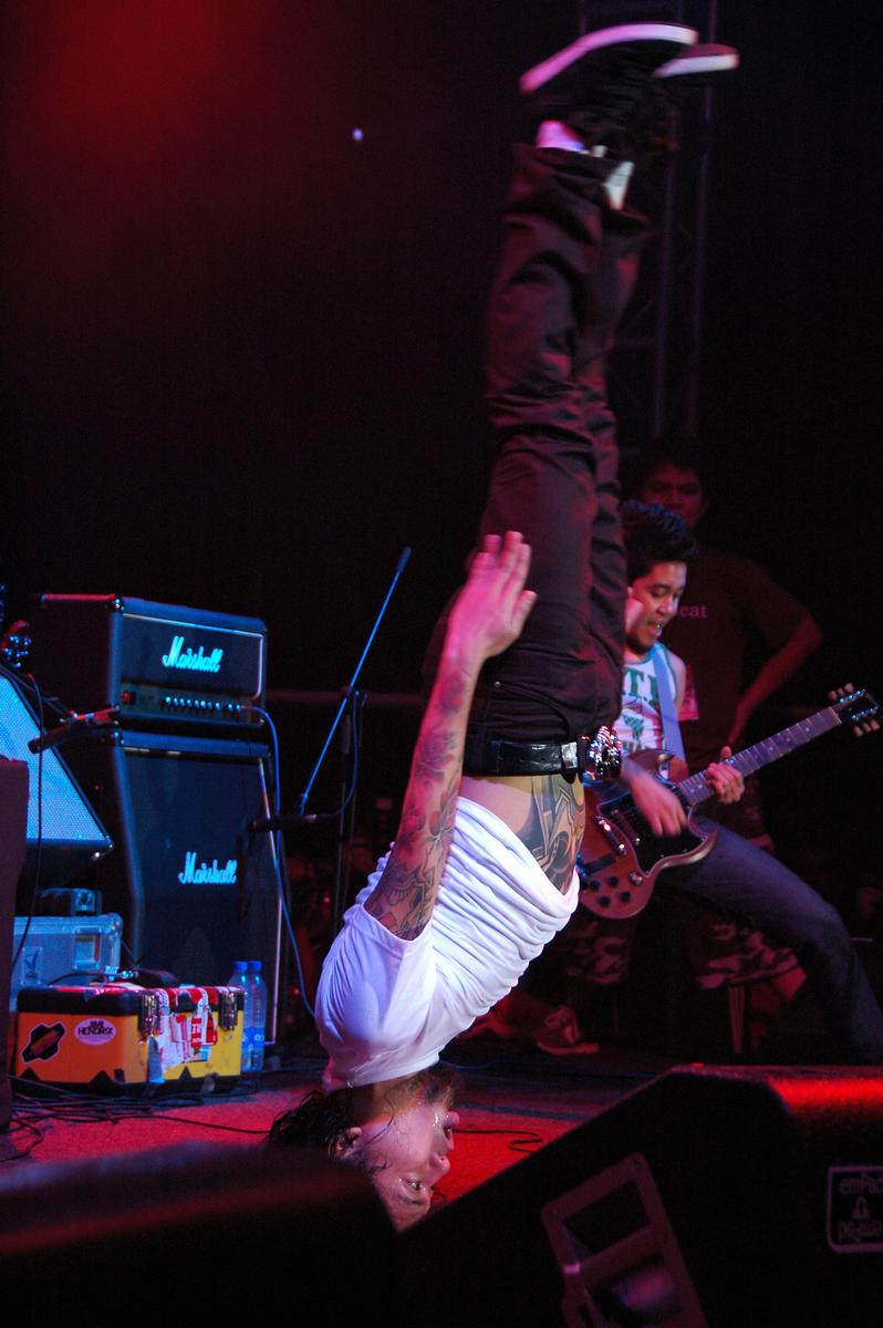 Lisandro Mendoza; The Headstand;The vocalist performing antics on stage to entertain the crowd.