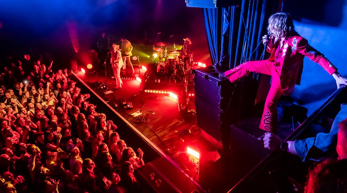  I happened to be taking photos of the show and while upstairs Louis climbed up the speaker so I quickly ran over and caught him performing and engaging with fans on the balcony.