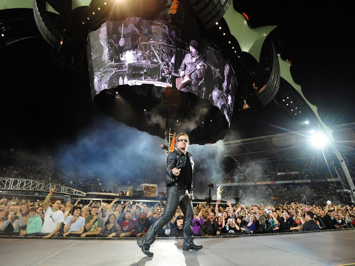 Craig Baxter;Bonovox;U2 lead singer Bono acknowledges  a photographer at Mt Smart Stadium