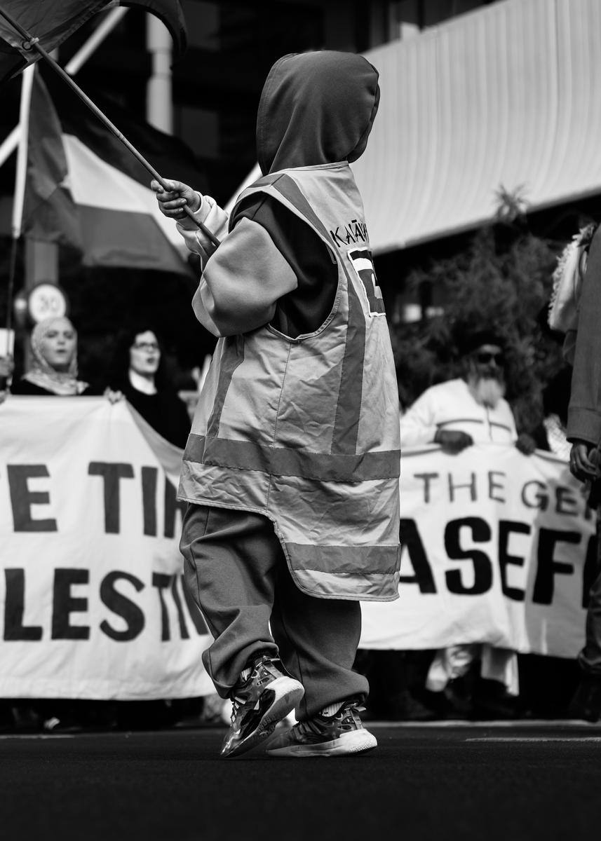 Daniel Clay;Never Too Young ;With this photo, I got down low in order to depict the child protester in a vasty powerful manner. This photo demonstrates the extent the world's issues affect society. Even the very young are affected. I like the way a young child is protesting as pose to an older being which is usually depicted as more normal. The child is depicted is a leader, leading the other protesters which again isn't something you would expect.