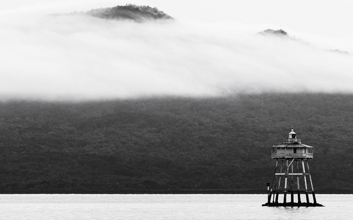 Daniel Clay;Volcanic Mist;On an early Saturday morning in June, I looked out the window and saw mist and fog in the distance, so I got on the Tamaki Link down to Tamaki Drive in hope of capturing the city skyline within the fog, however when I arrived there was no fog or mist to be seen near the city. I did however notice some rather interesting mist on Rangitoto's peak, so I spent an hour capturing various different frames of the mist. I think the mist in the photos create a very dramatic scene and I used my telephoto 70 300mm to get up close to the scene. Rangitoto in my opinion, is the highlight of Auckland is a special site under protection and management by the Department of Conservation, so I think it fits well with theme of 'Sustain'.