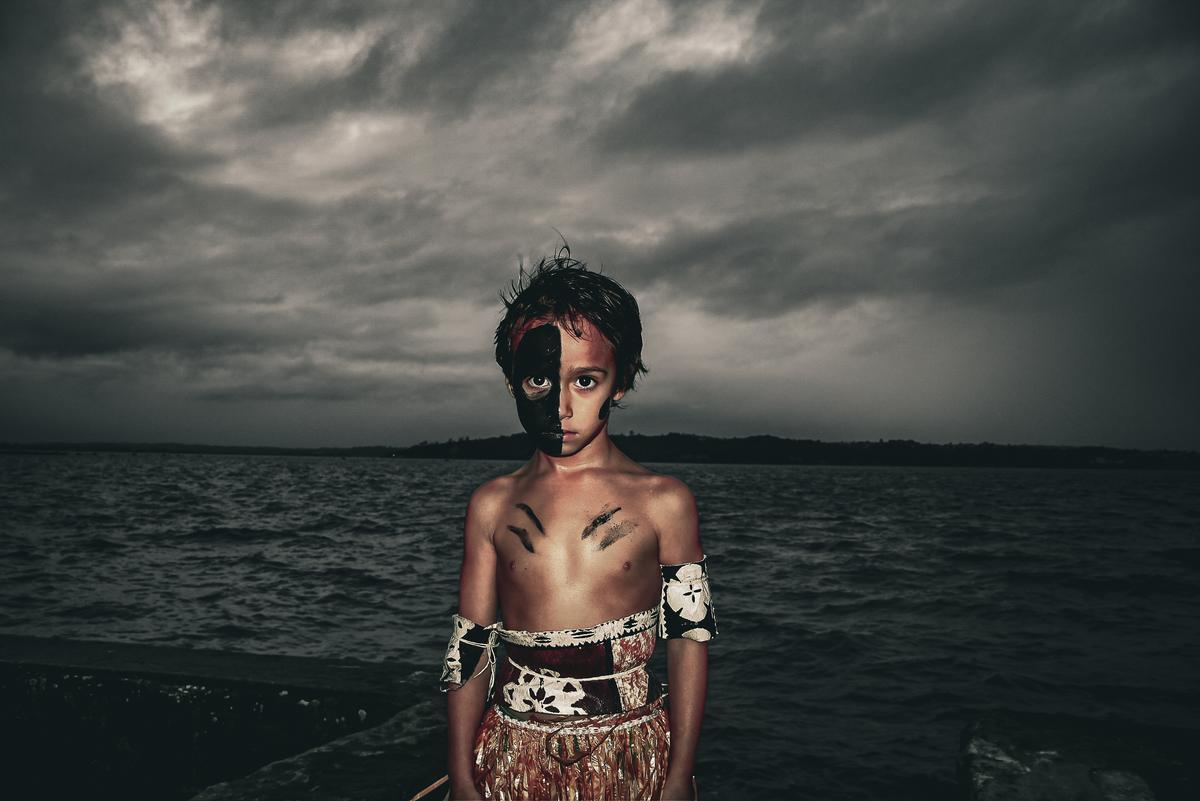Isabella Nabouta;Na Bati Lailai   The Young Warrior;Inspired by Raude by Black Rose, this image of my little brother Jireh in traditional Fijian warrior wear reflects our people’s strength, sacrifice, journey   themes echoed in the stormy sea and Jireh’s Cakaudrove heritage