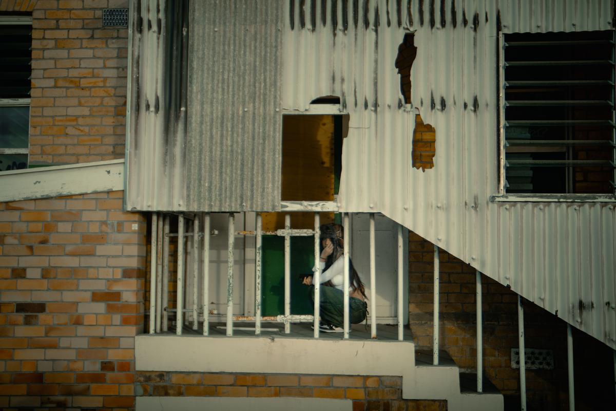 Lucas Lin;Hidden away;29/03/25. A sole figure obstructed by abandoned walls portraying a trapped curious figure being overtaken by her rugged environment.