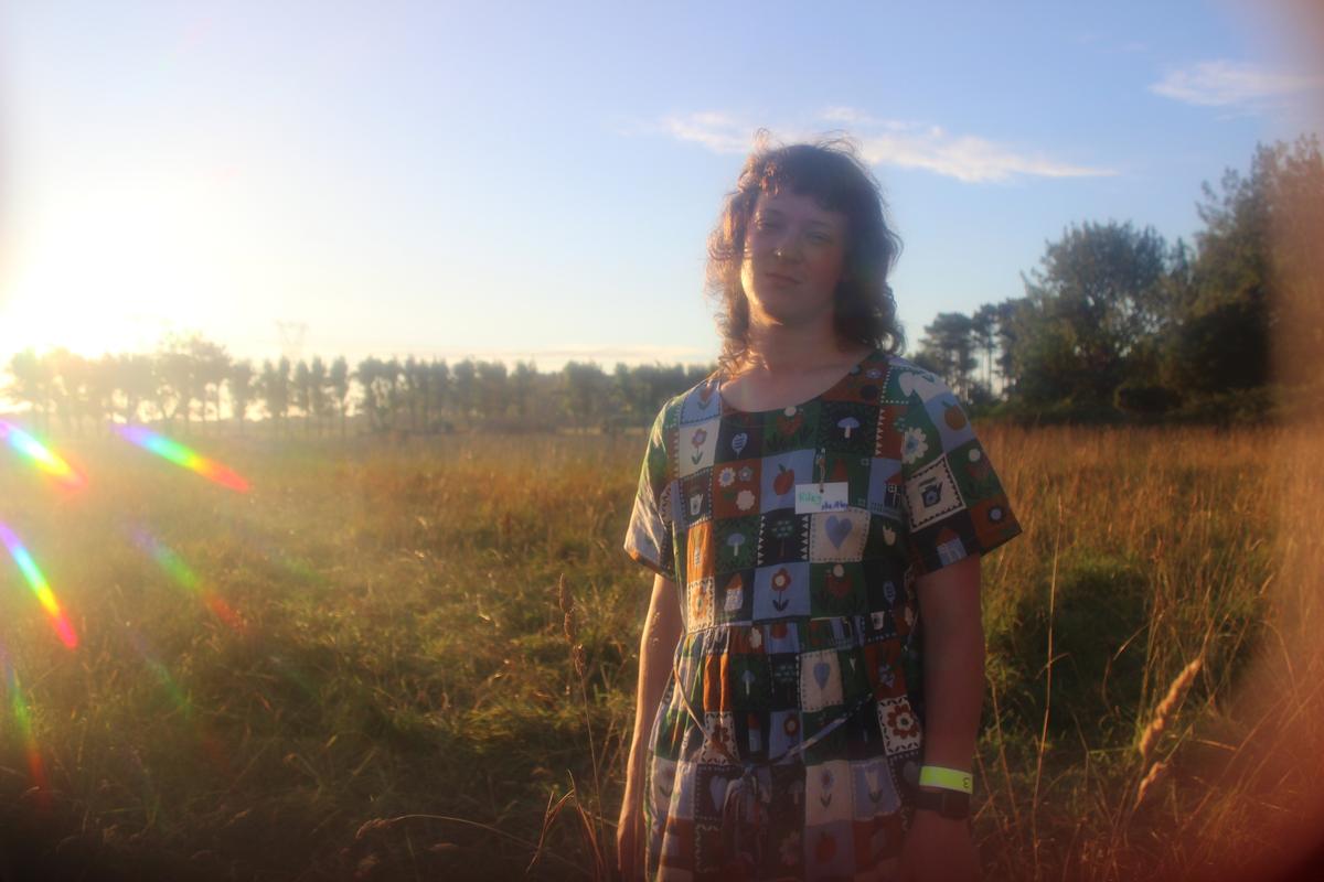 Mars Cook;Spectrum;This is of someone I know called Riley, we met at a volunteer run camp focused on nature, collective action and political organising. It was full of all kinds of people including queer and trans people and I felt very at home. I was running around the camp at the last hour of the camp asking everyone if they wanted a portrait and she said yes. I used firework glasses I got for $2 to turn the sun into a rainbow star and to soften the image.