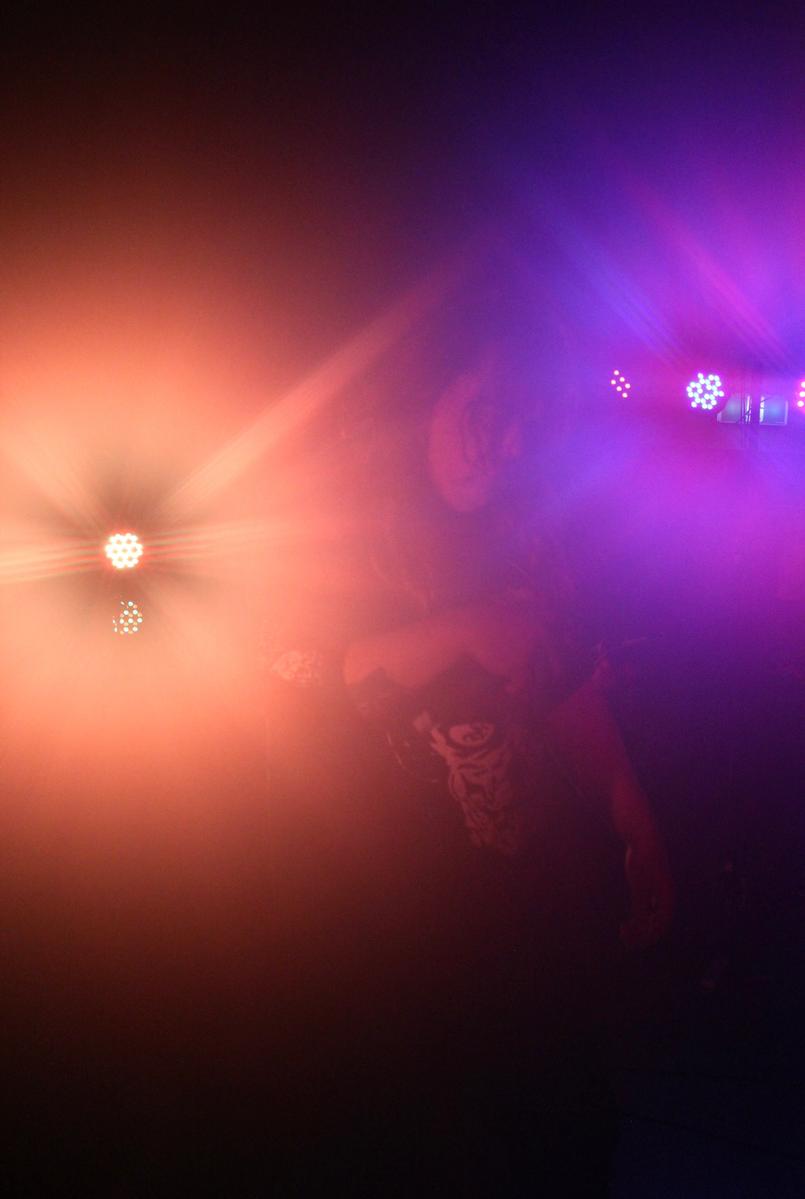Mars Cook;Fog;This photo from Fullnoise 2025 has huge halos around the singer because my camera lens got fogged up along with the windows from how many people were in the room and how intense the moshpits were. I decided to delay wiping it off for a few minutes and play around with the condensation and blurryness.