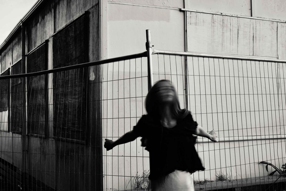 Nina Dorday;Unbound;This photo explores the idea of control — how people are boxed in, watched, or held back. Standing just outside the fence, the figure blurs with motion, caught between resistance and freedom. It captures the moment of stepping beyond what’s meant to contain you, even if the boundaries still feel close.