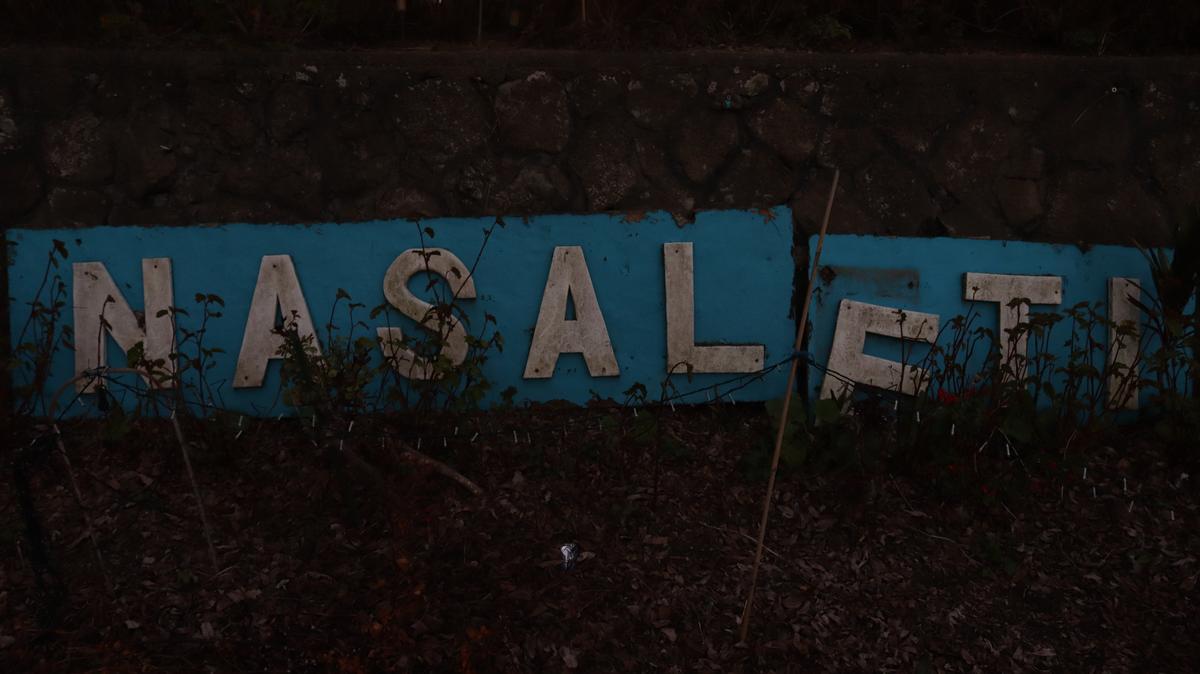 Rose Fifita;Nasaleti;This worn sign marks the entrance to Nasaleti, my Tongan church. Time has chipped at the letters, but the meaning remains untouched. To me, it reflects how our cultural roots may weather and shift, yet their strength stays grounded in memory, faith, and pride.