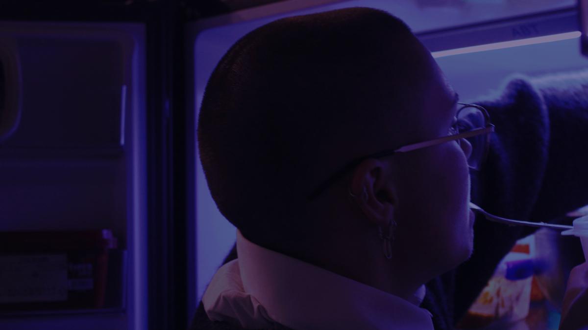 Uriel de Proença Ruiz;Liminal Hunger;Drawn to the fridge's glow, the subject embodies a universal craving for food, for pause. Caught between darkness and cold light, this image dwells in a liminal space where the rich purples and shadowed details lend a cinematic intensity to an otherwise mundane, human act.