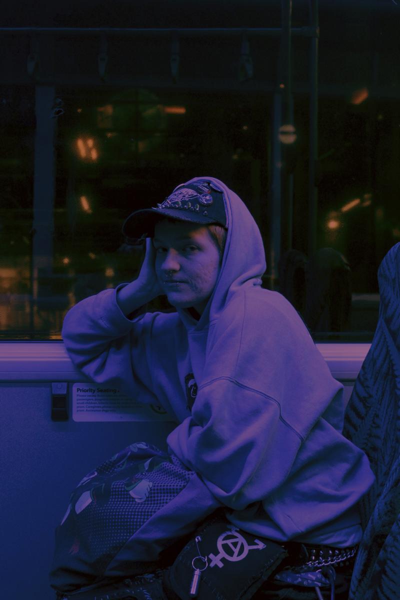 Uriel de Proença Ruiz;Next Stop: Home;Shot on a calm night ride through Central Auckland, this photo represents more than the journey. It’s about a moment of quietness, a comforting look shared between souls, depicting the kind of companionship that makes even a bus ride feel like belonging. Home is where the heart is.