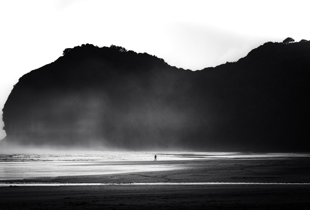 Yechang chen;Minimalist Lament: Silhouetted Horizon;A minimalist masterpiece, this black and white seascape employs a lone silhouette to evoke existential solitude, with fog lending a surreal dimension. The tonal range is compelling, yet a refined contrast in the mid tones could heighten the dramatic tension.