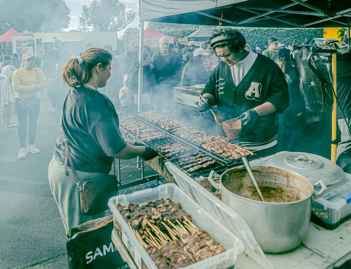 Margaret V Vickers;Grilling food at the Philippines Independence Day celebrations.